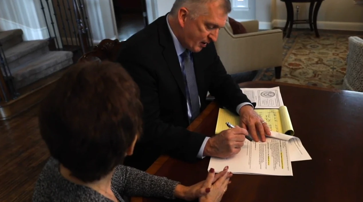dan atkerson reviews paperwork with a client