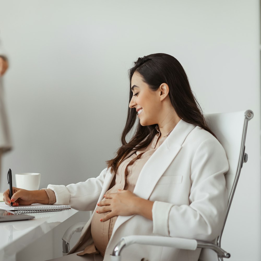 Pregnant woman smiling at work