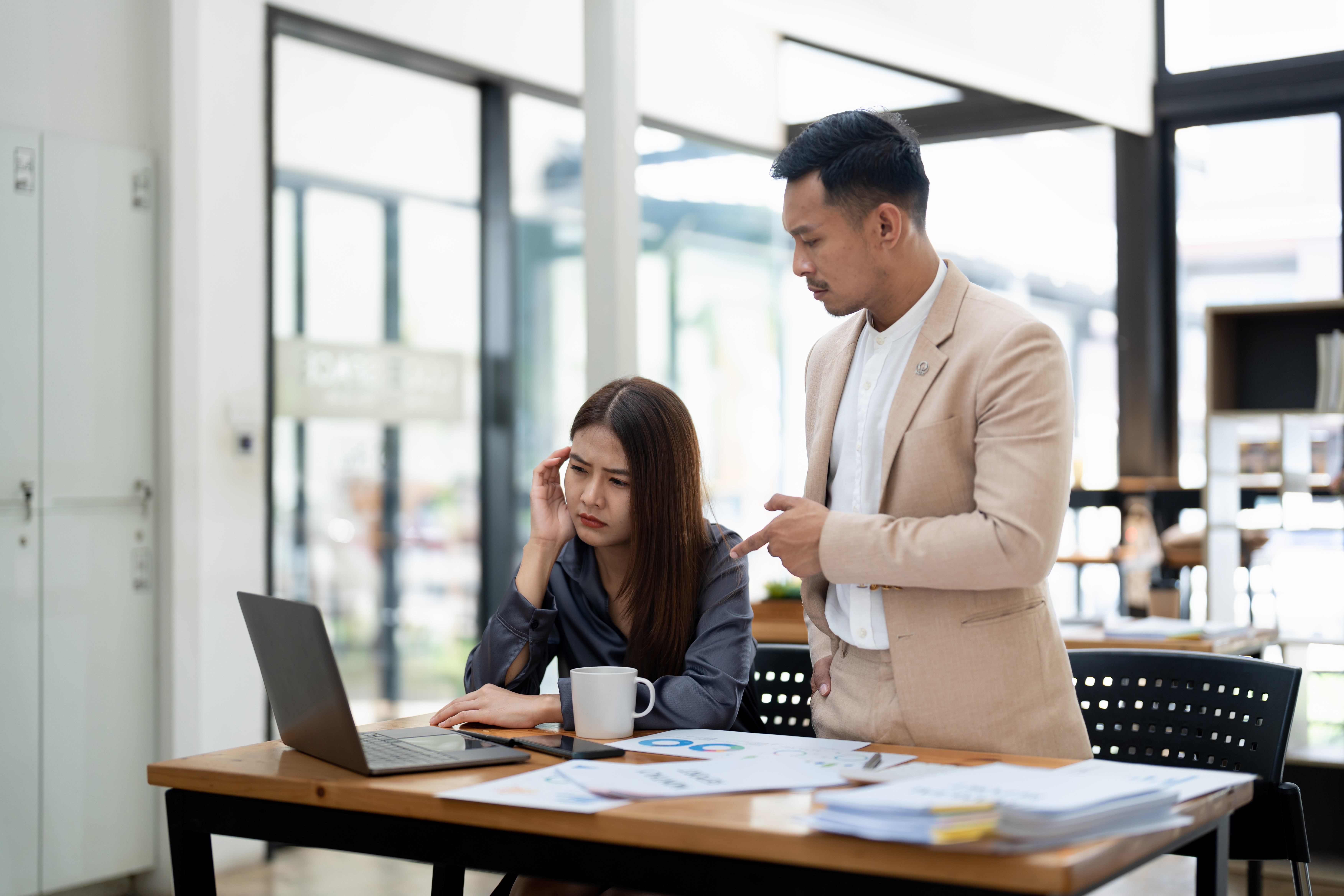 Male boss scolding female employee