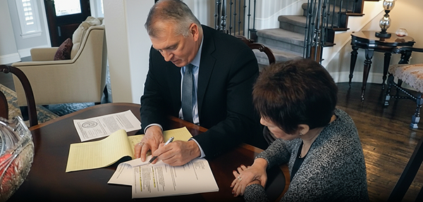 Attorney Atkerson going over paperwork with a client