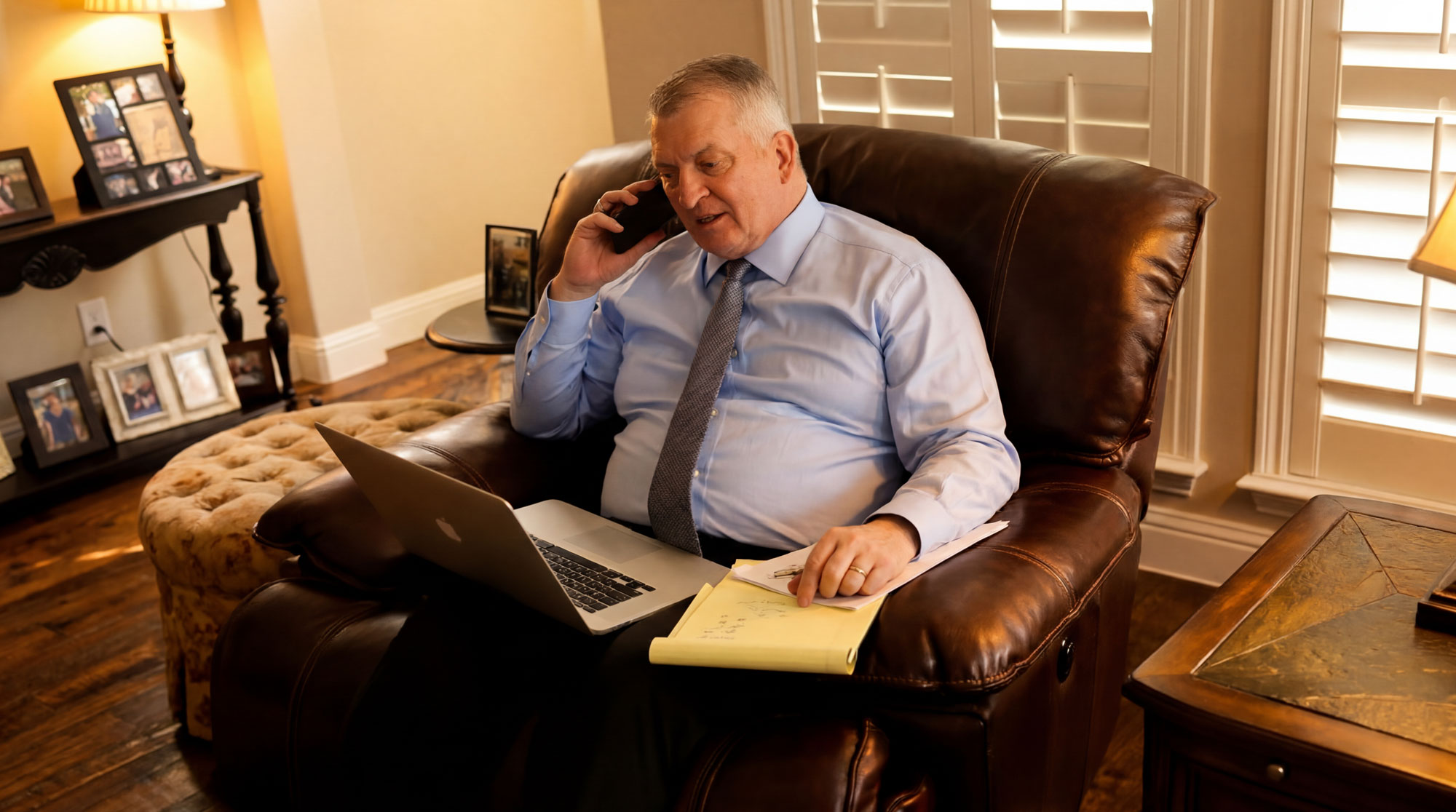 Dan A. Atkerson on the phone with a laptop
