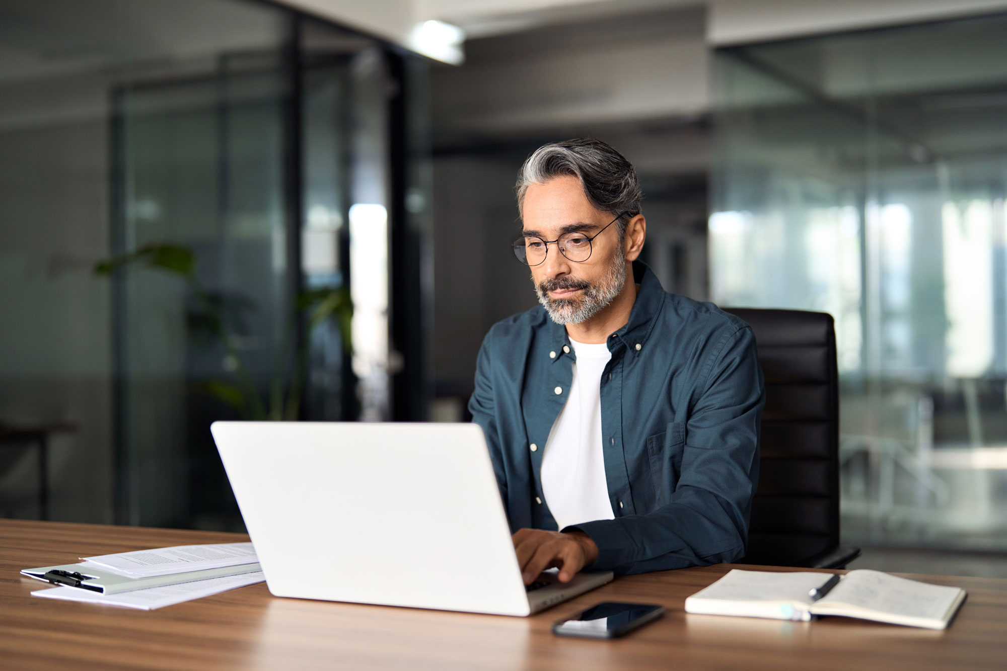 Man at a desk working on a laptop