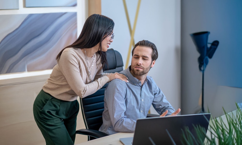 woman touching man's shoulder