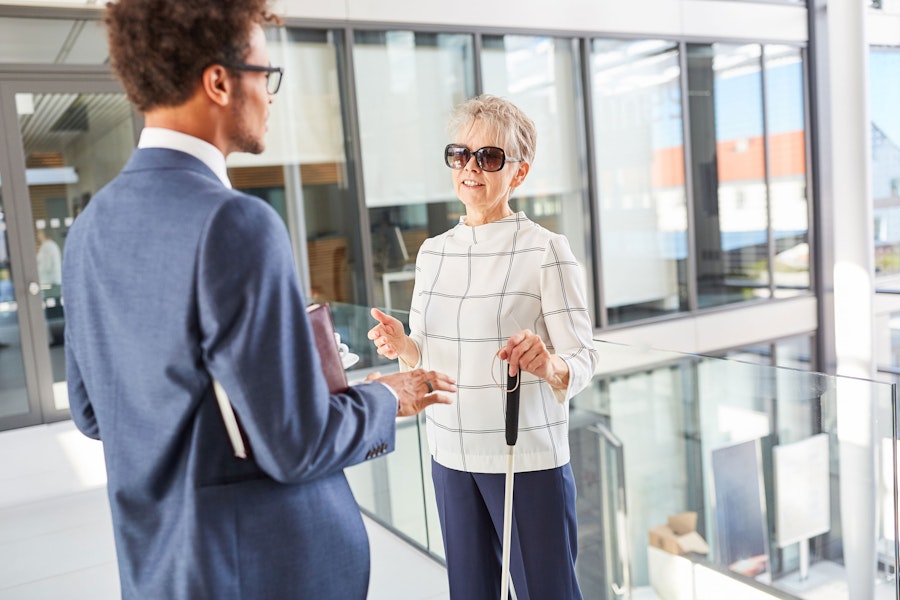 Blind woman speaking with coworker