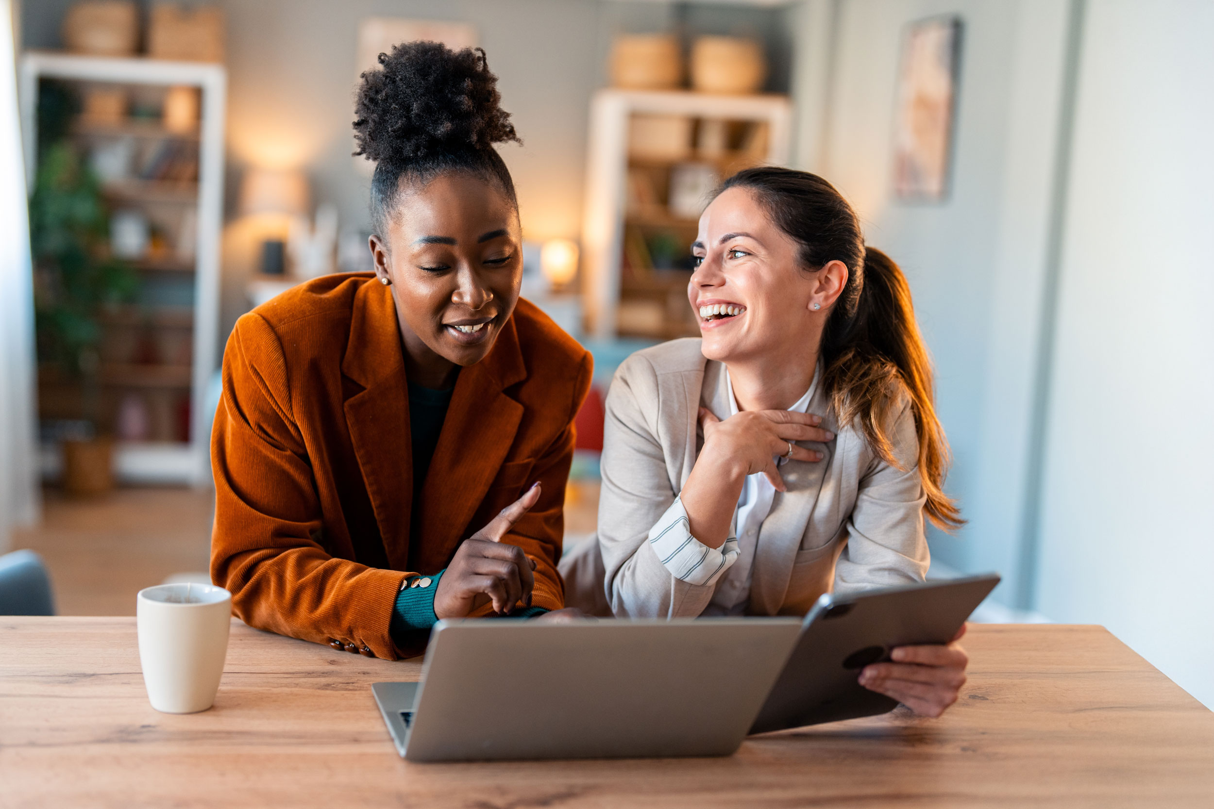 Two coworkers smiling while working together