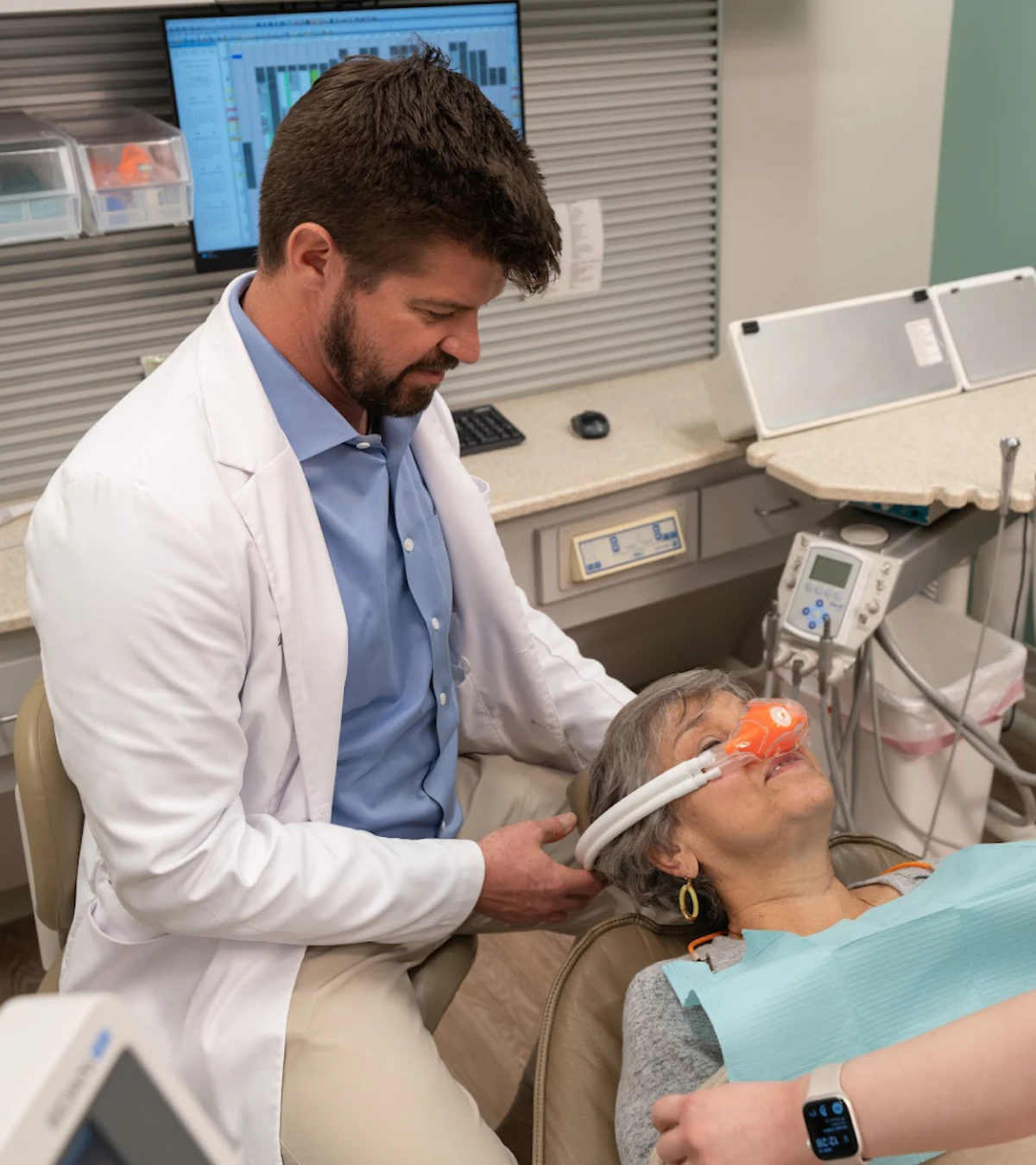 Dr. Gooch administering nitrous oxide sedation to a relaxed patient at Gooch Family Dental