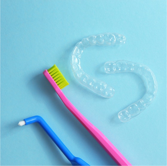 toothbrush, waterpik, and invisalign aligner