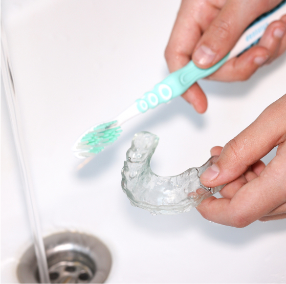 brushing an invisalign aligner