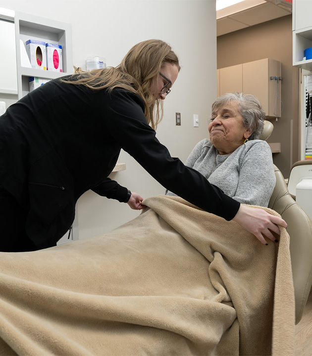 Team member covering a patient with a blanket