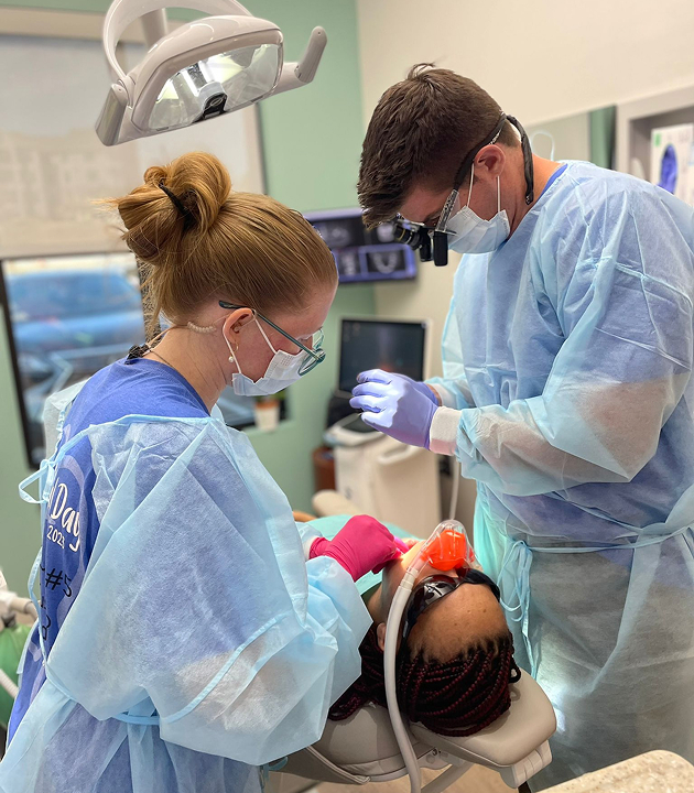 Dentists working together with patient