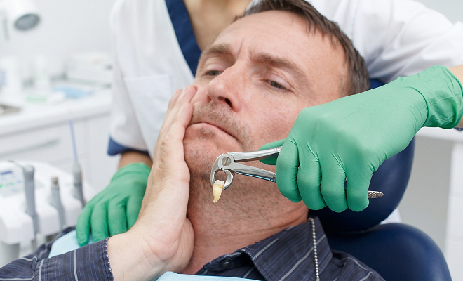 Man getting his tooth pulled