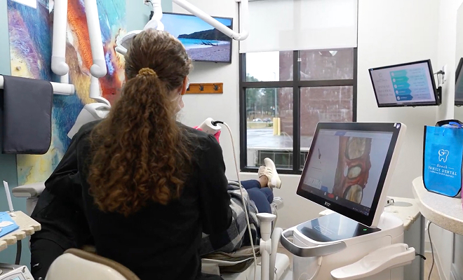 dentist looking at a scan of a missing tooth