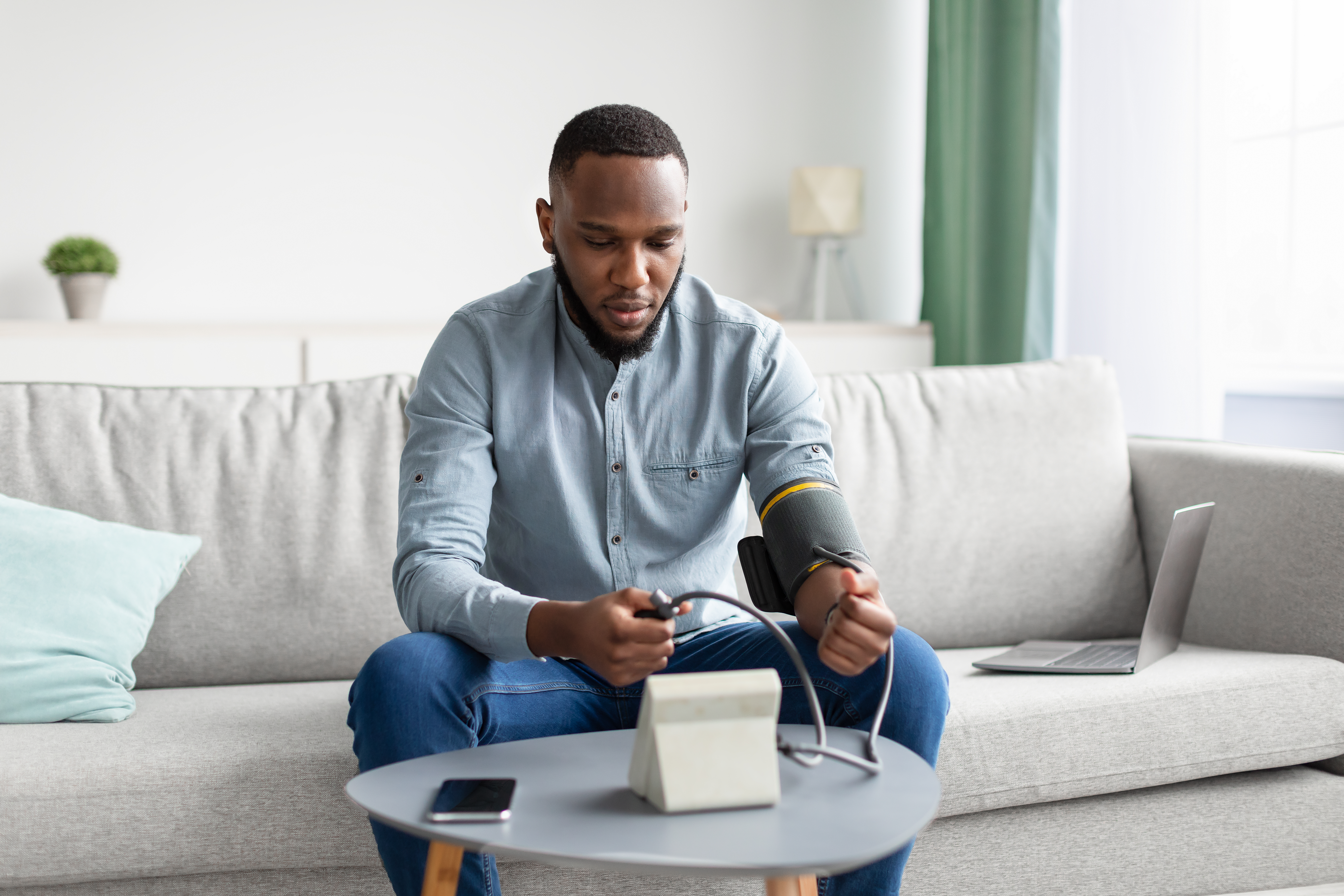 young adult male taking his blood pressure
