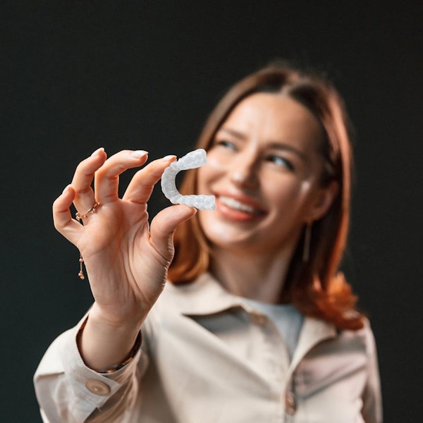 Woman holding Invisalign