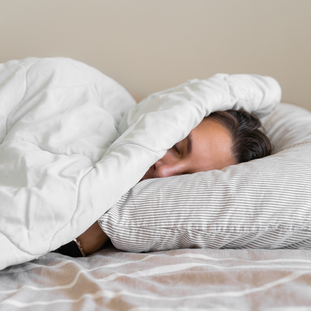 sleeping woman under covers