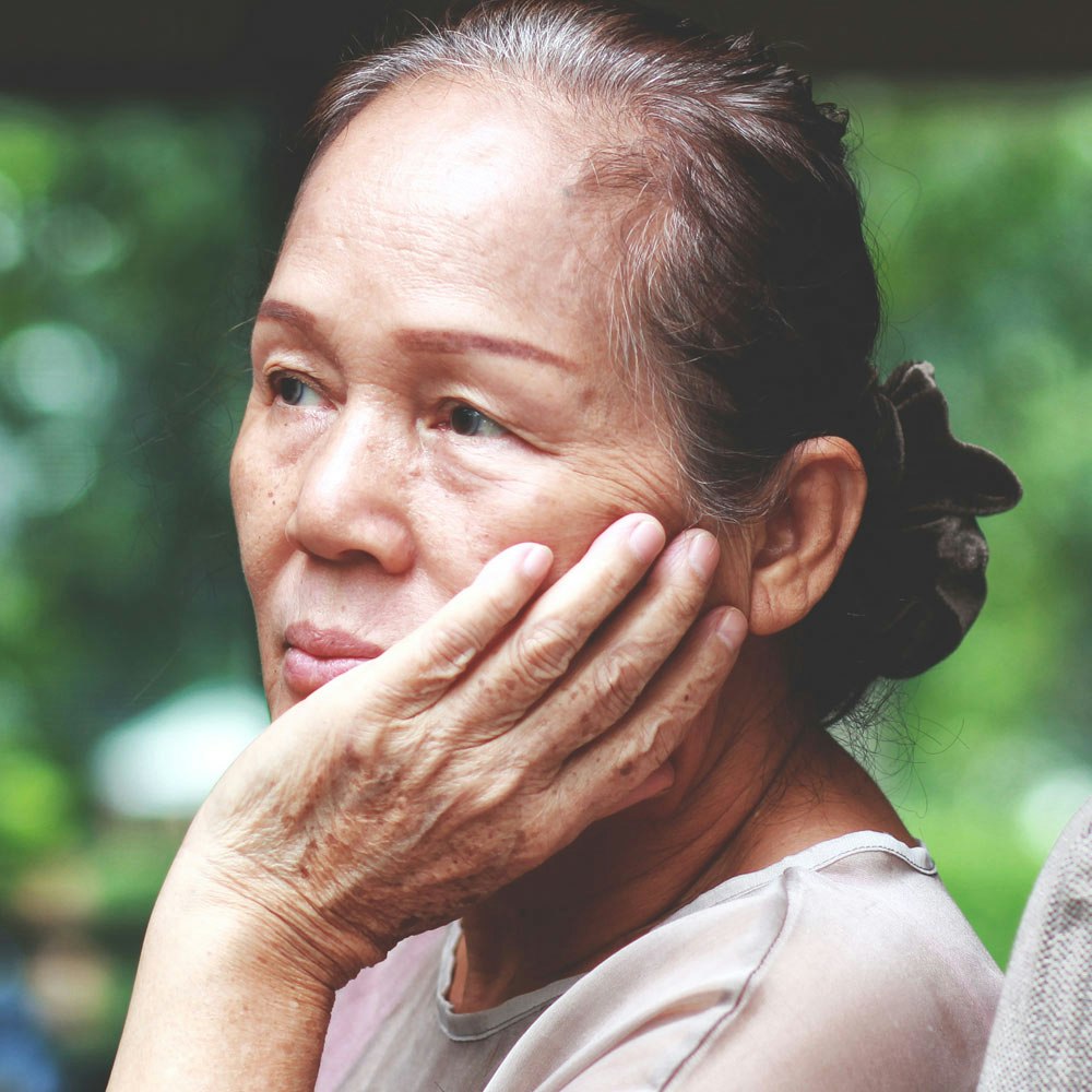 Mature woman looking out window