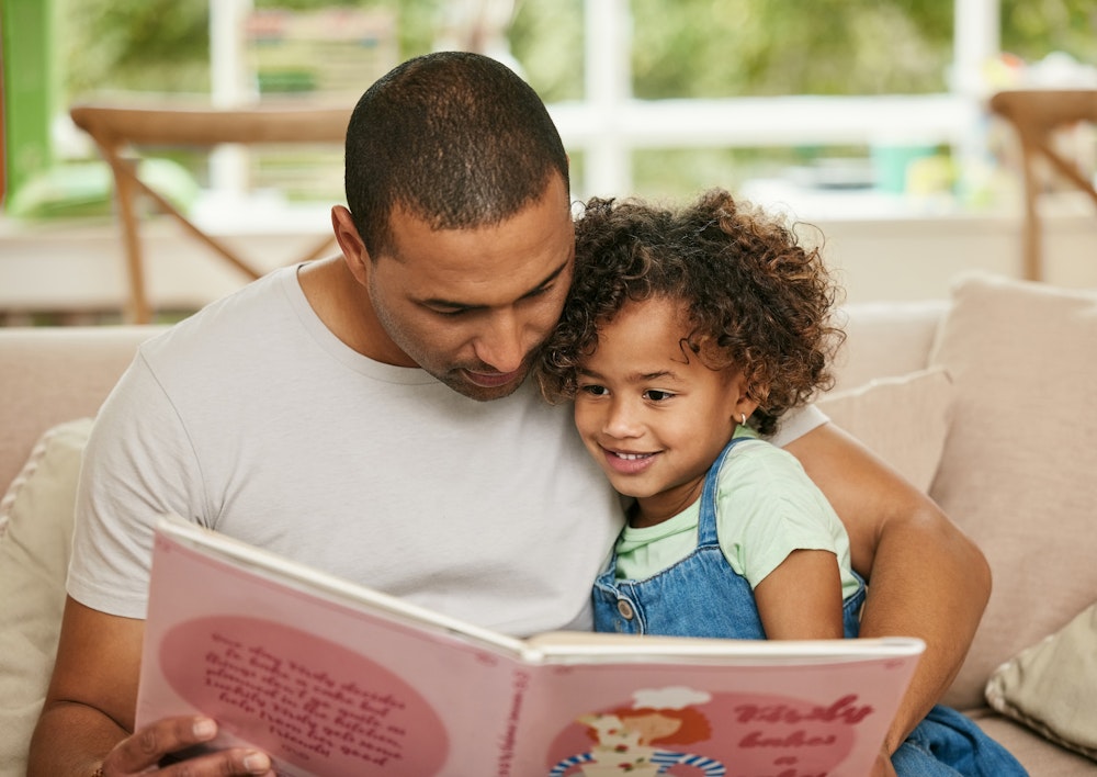Father reading to daughter