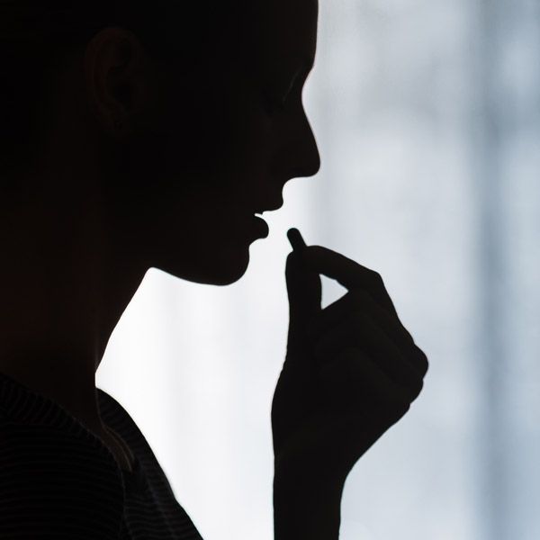 woman taking pill