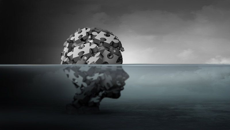 illustration of head made of puzzle pieces below surface of water
