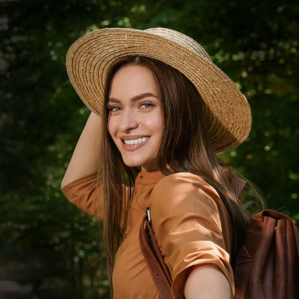 Woman wearing sunhat smiling at the camera