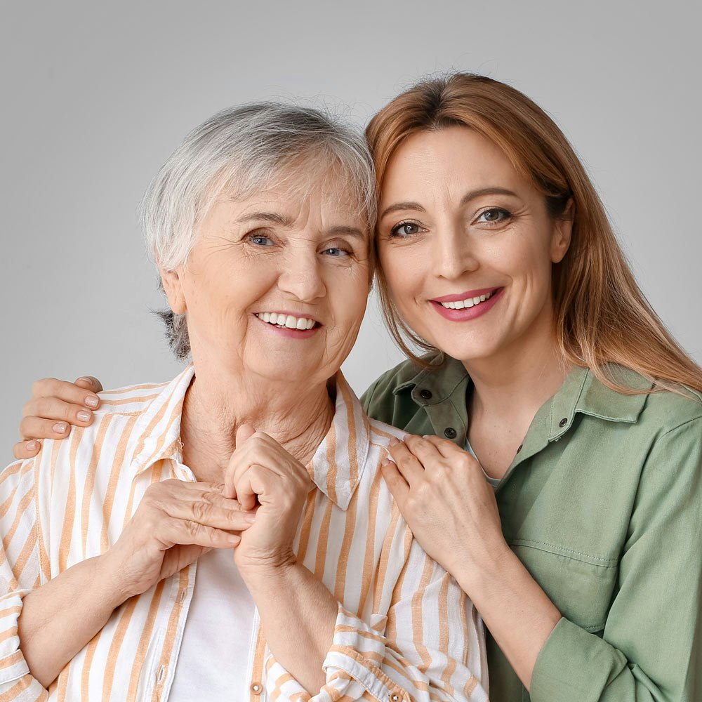 Smiling elderly woman and mature woman