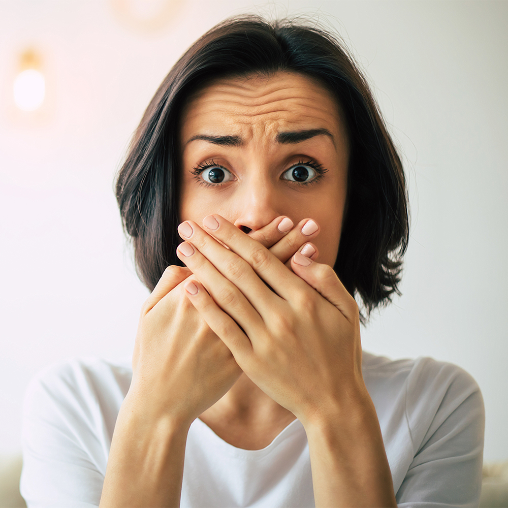 Woman covering her smile