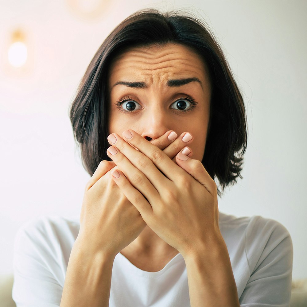 Woman covering her smile