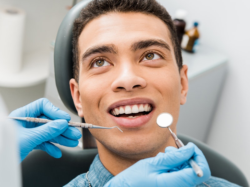 man at dental office before oral cancer screening