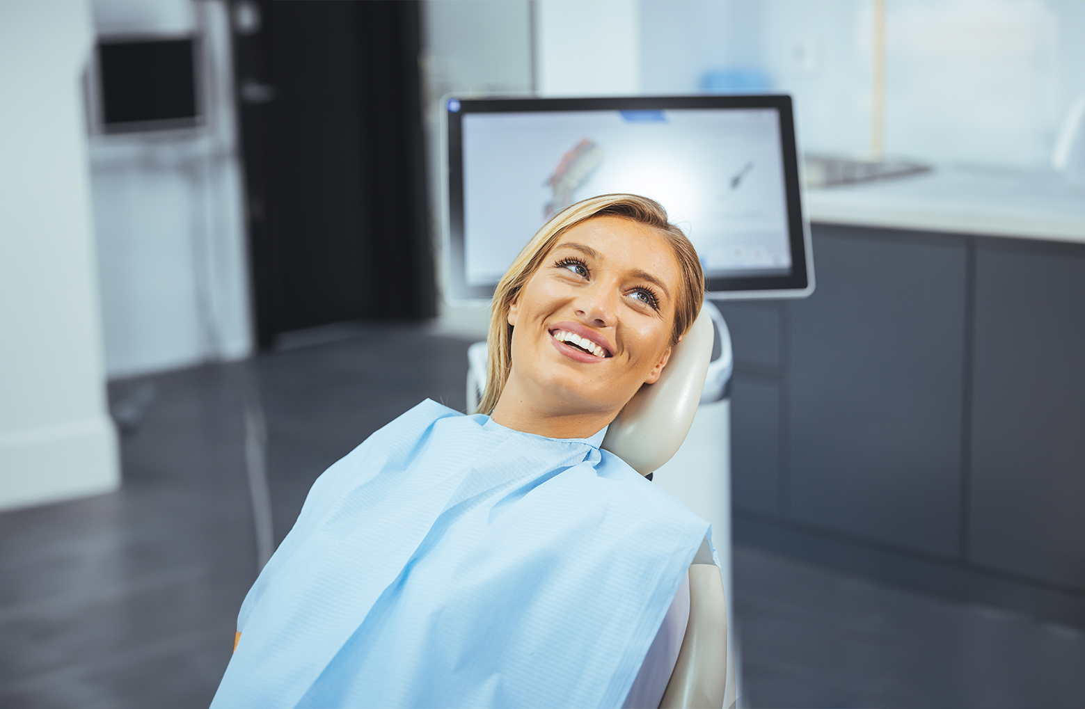 Young woman smiling at the dentist