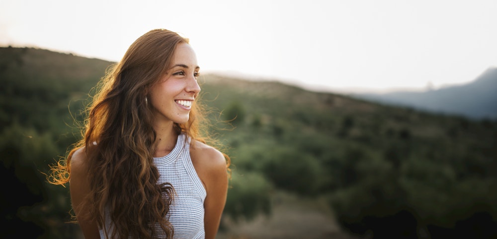 Young woman smiling while hiking