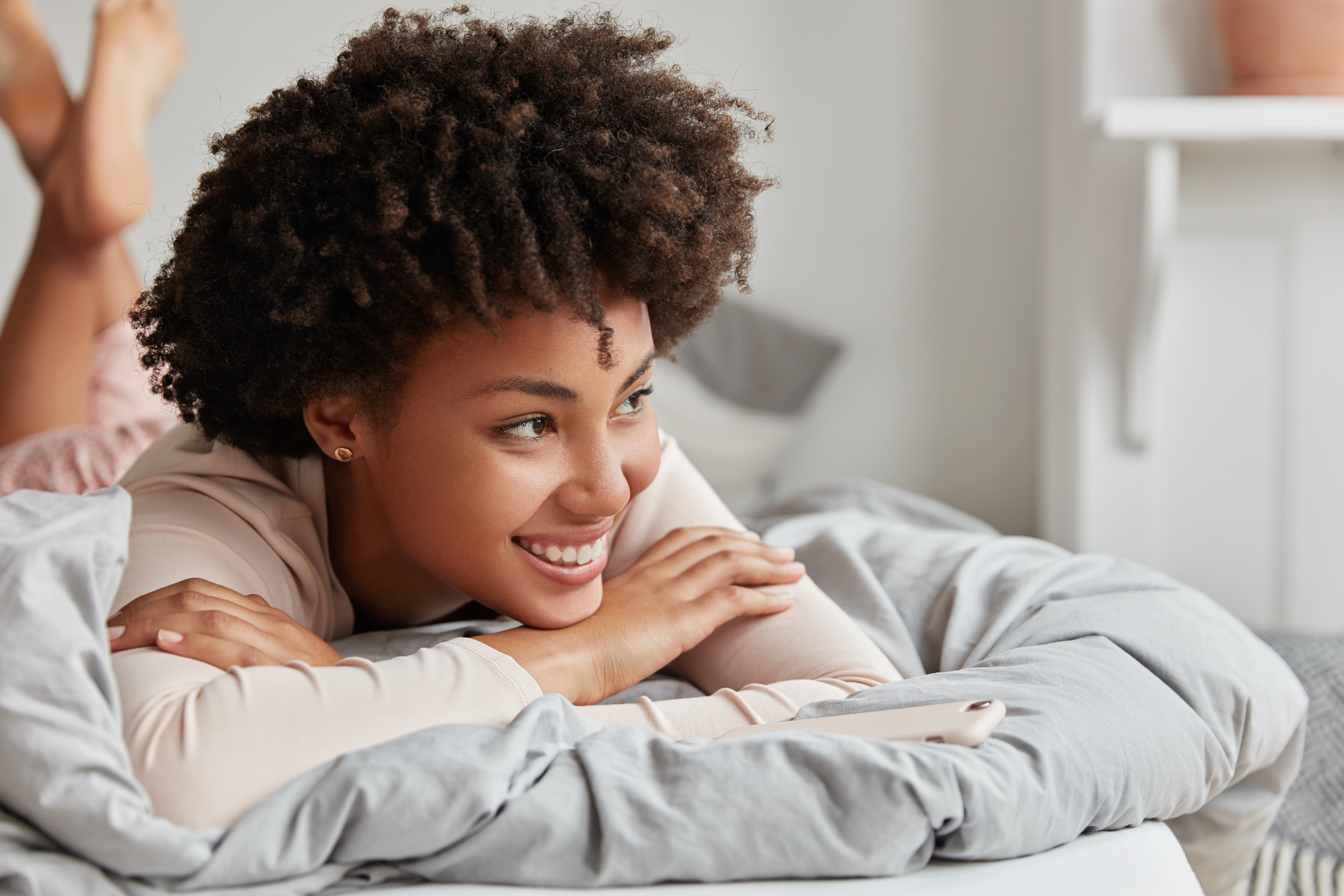 Young woman in bed smiling