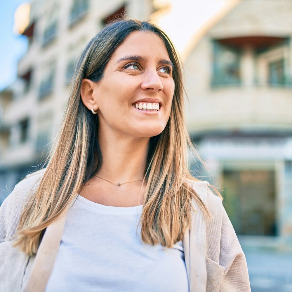Woman flashing her restored smile while walking downtown