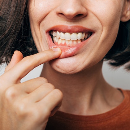woman with finger to her lip