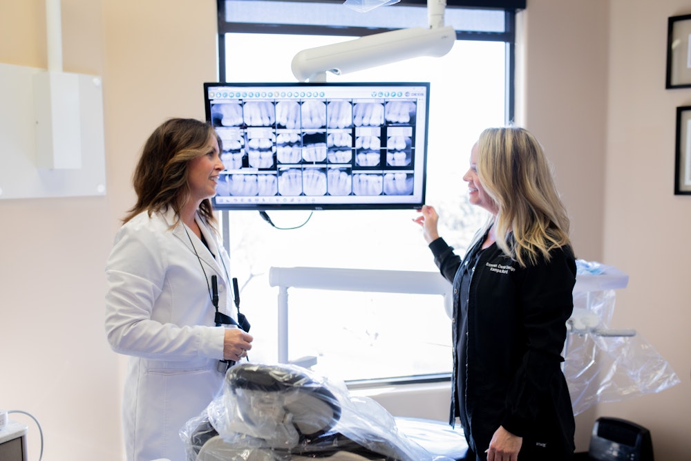 dentist and staff working on a patient