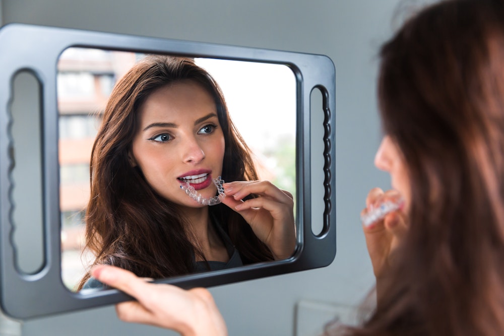 Woman placing Invisalign