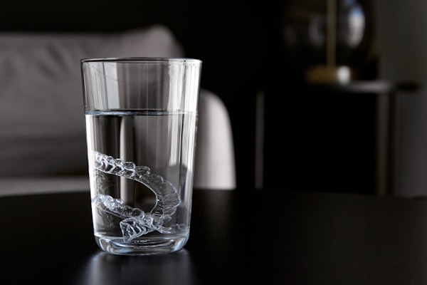 Glass filling with water and Invisalign trays
