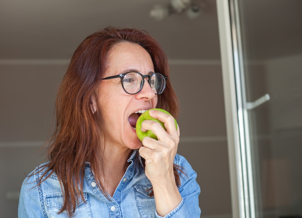 Woman biting an apple
