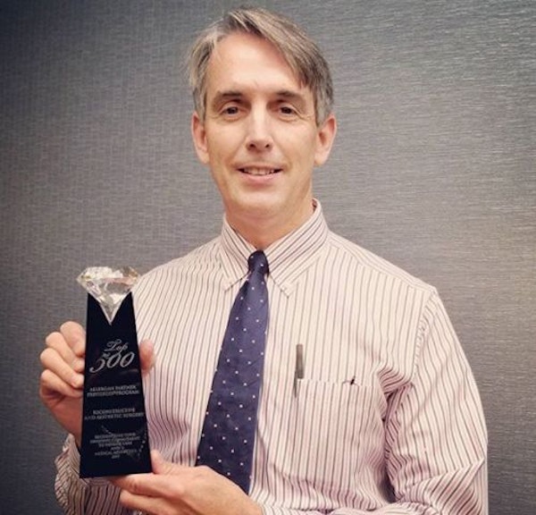 Dr. Zavell holding an award