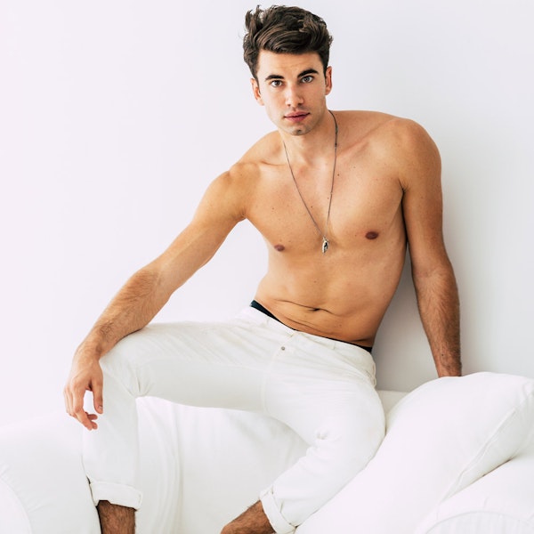 Shirtless man in white tight pants with liposuction procedure