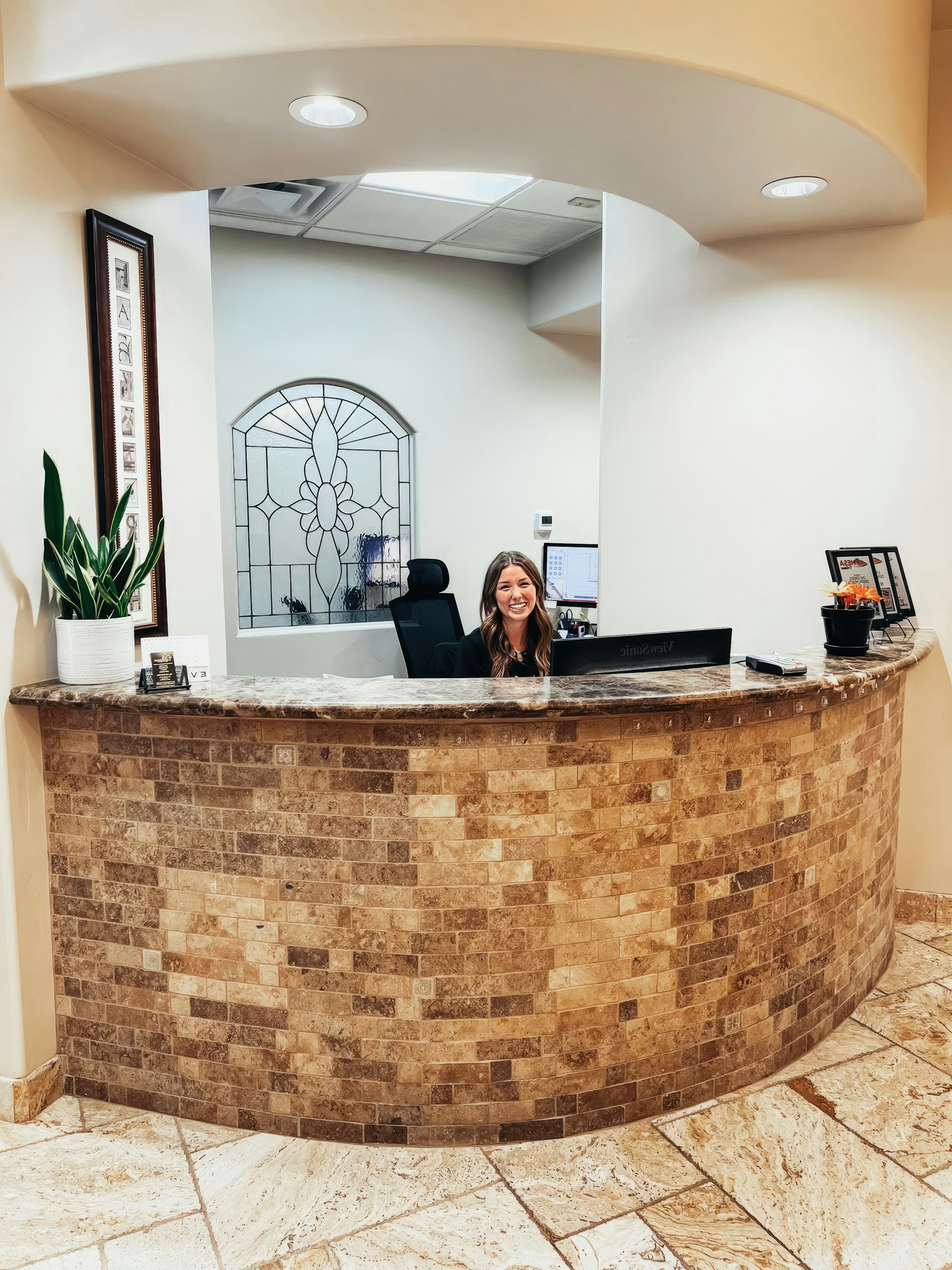 woman smiling at front desk