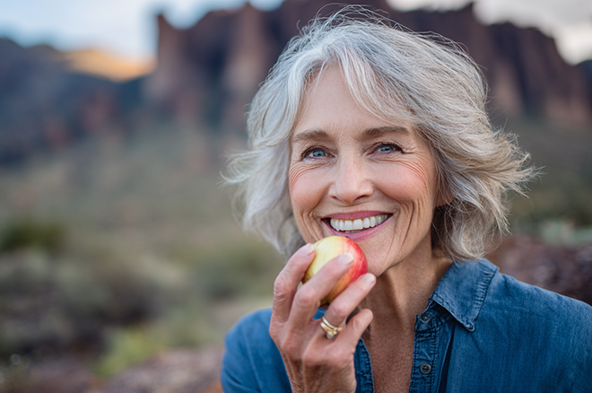 senior woman eating an apple