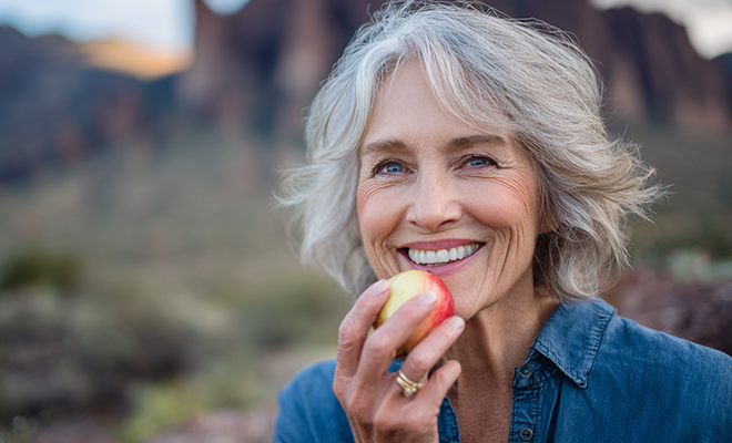 senior woman eating an apple