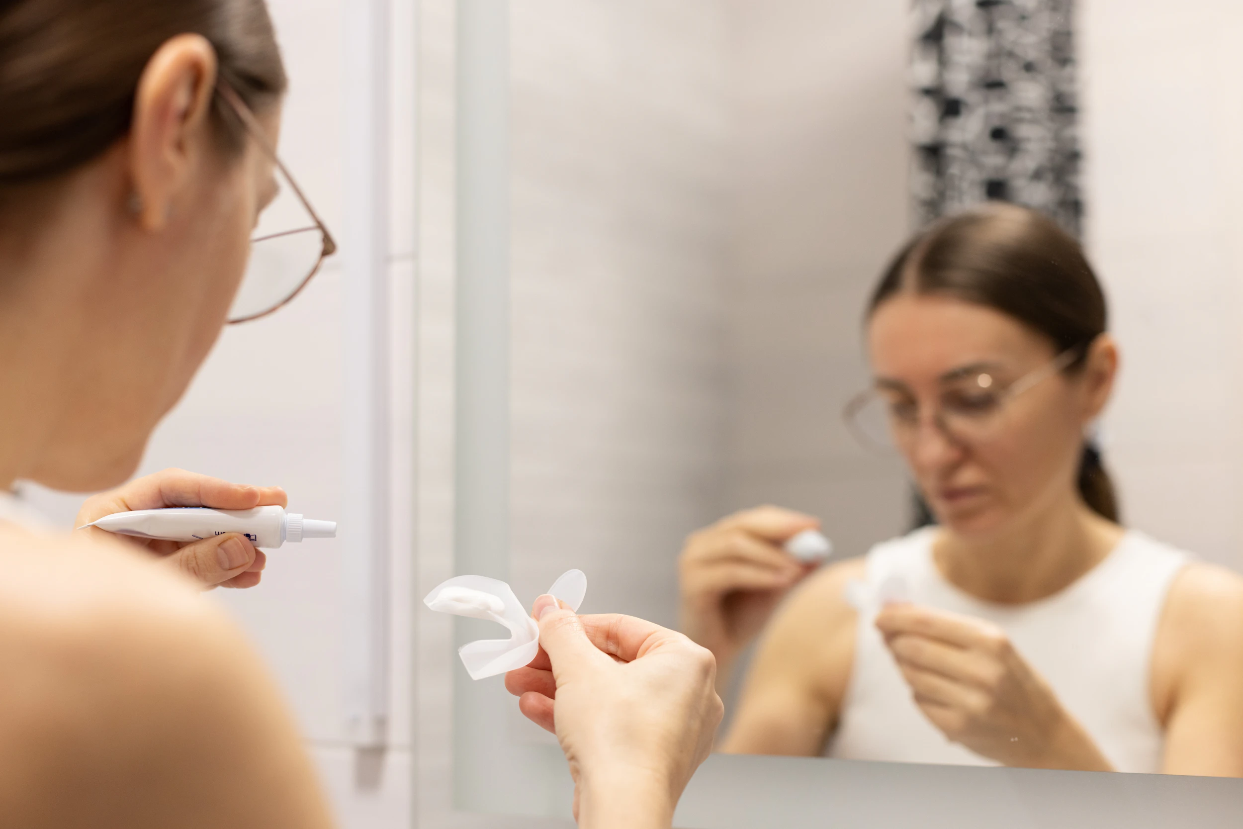 Woman filling an at-home whitening tray