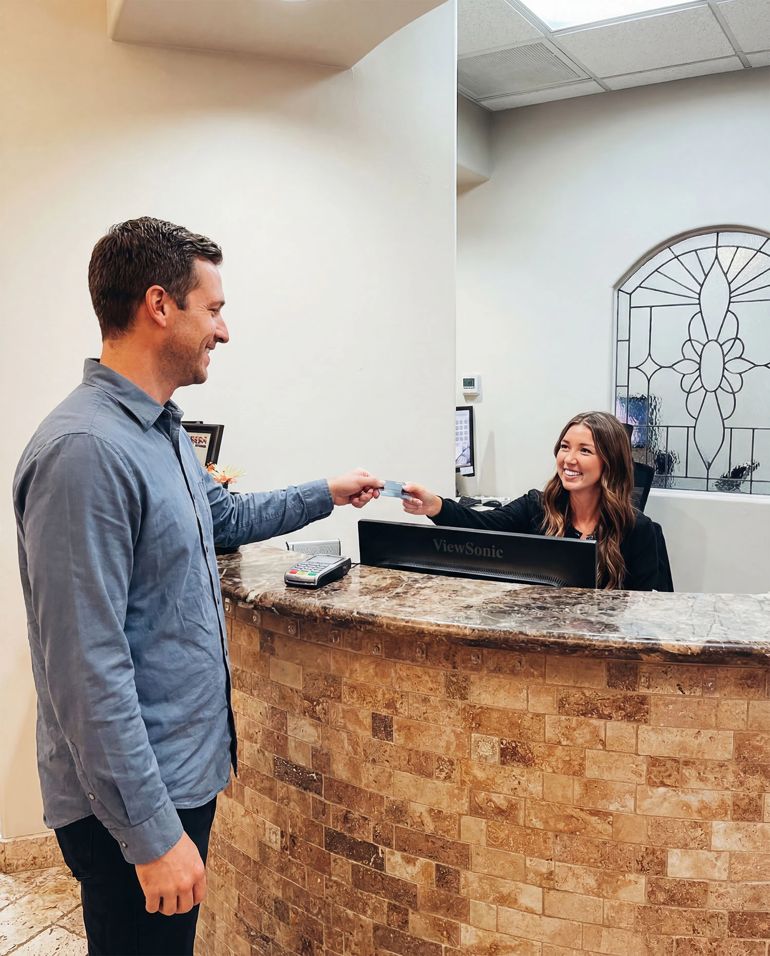 man paying for dental services