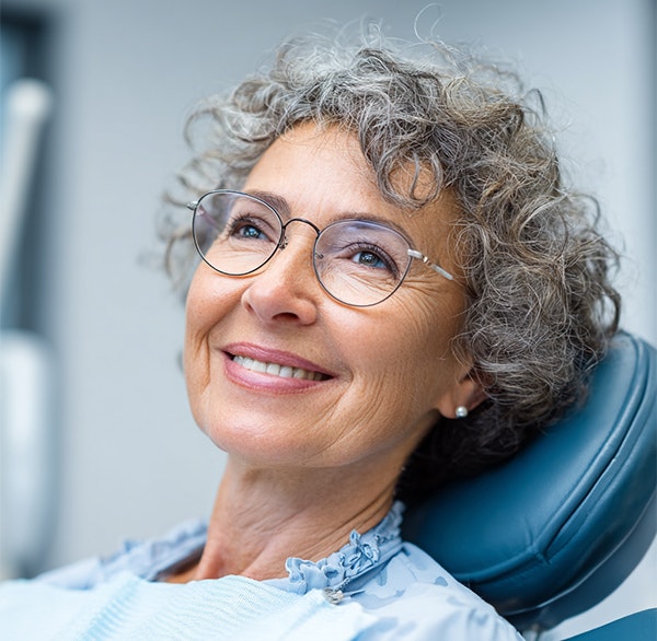 Smiling elderly woman with dental implants