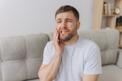 Man in dental pain from grinding his teeth