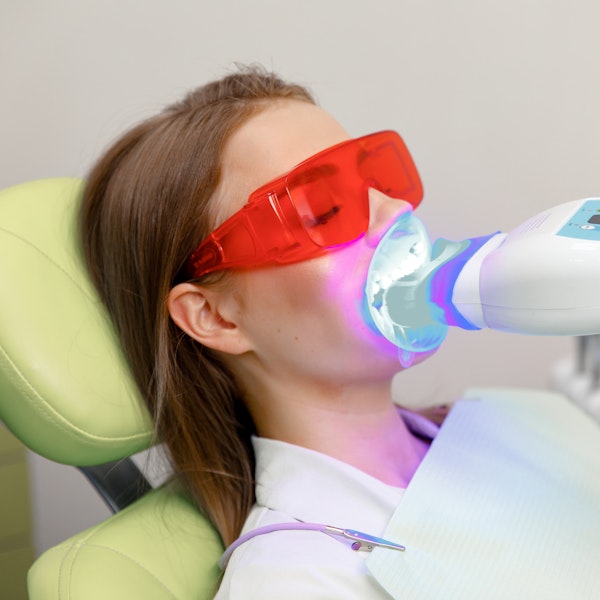 Woman undergoing professional teeth whitening