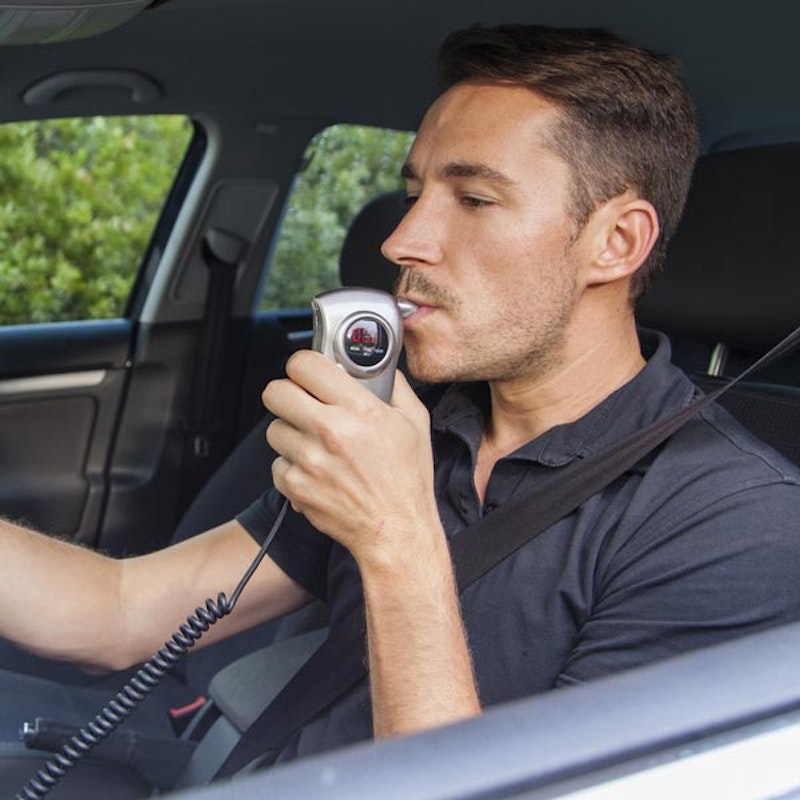 man submitting to breathalyzer test