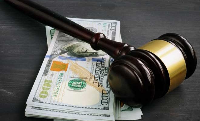 Gavel on top of cash