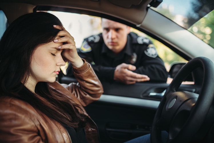 a woman being pulled over by a police officer